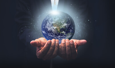 Businessman holding the earth with global connection concept. Energy saving concept, Elements of...