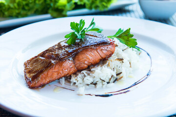 Salmon fillet under teriyaki sauce with rice