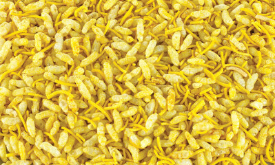 Sev Mamra Garlic, Salted & spices is an Indian snack. It is a mixture of spicy dry ingredients such as puffed rice, savoury noodles and peanuts, Background Image.