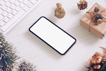 Mockup blank white screen smartphone on home office desk  for Christmas and New Year party background concept, Flat lay top view with copy space for your Merry Christmas and Happy New year artwork.
