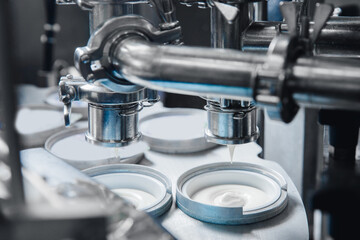 Food production, dairy plant. Automated filling of yoghurt into packages