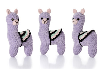Knitted toy. Lilac lama on white background. Three position. Full depth of field. With clipping path. © gna60