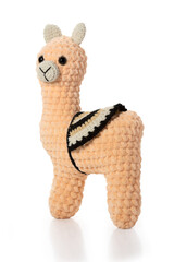 Knitted toy. Orange lama on white background. Full depth of field. With clipping path.
