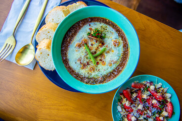 Jeju Island,South Korea-March 2019: Top view image of curry with bread on a blue bowl and wooden...