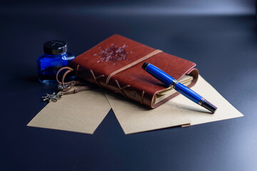 blue pen with book and ink