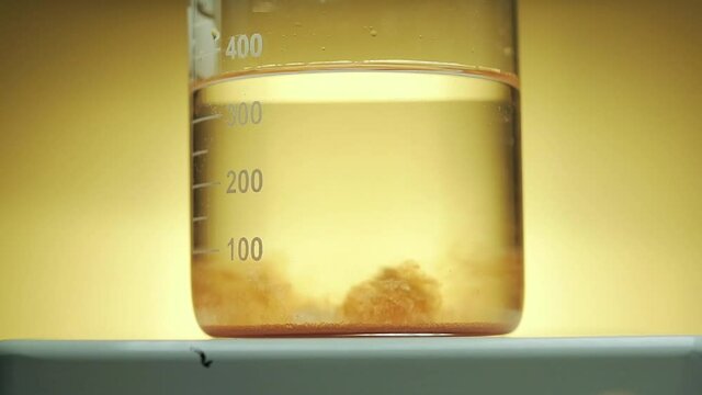 Close-up slow motion of the mixture in the test tube. collagen test. water solubility test. Laboratory processes.