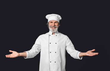 Mature male chef on dark background