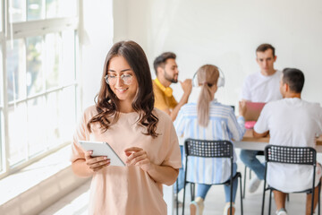 Students with modern devices studying online indoors