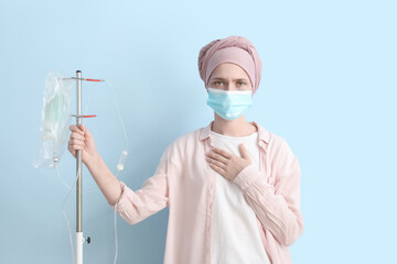 Woman undergoing chemical therapy course against color background