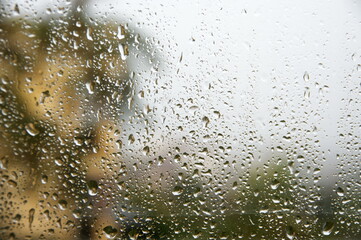 View through window with water drops at rainy weather