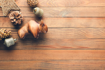 New Year composition with figurine of bull on wooden background