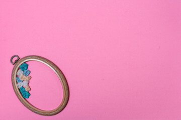 embroidery hoop on a pink background. space for text