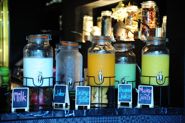 the bottle of  juices with many food on table at party event
