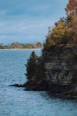 sheer cliff edge with trees and water around