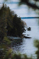 sheer cliff edge with trees and water around