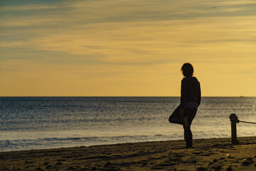 Fototapeta premium Woman exercising on beach at morning.