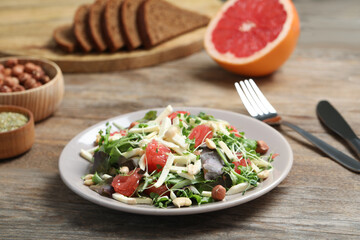 Delicious carrot salad served on wooden table