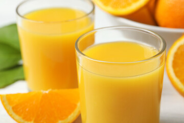 Glasses of delicious fresh orange juice, closeup