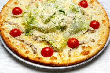 Caesar pizza decorated with sherry tomatoes close up