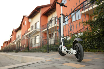 Modern electric kick scooter on city street
