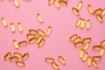 Vitamins Omega 3 6 9 fish oil , vitamin D on a pink background for health lifestyle