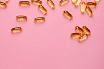 Vitamins Omega 3 6 9 fish oil , vitamin D on a pink background for health lifestyle with copyspace