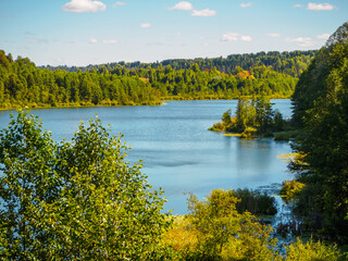 Beautiful view of forest lake Puzhanier in sunny summer day.