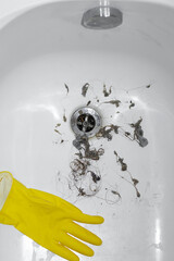 cleaning dirt and hair near drain hole