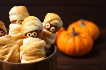 Spooky sausage mummies for Halloween party served on table, closeup