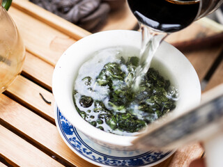 Chinese green tea is brewed in ceramic gaiwan