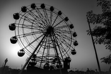 Ferris Wheel in a park against Sunlight Black and White Photo