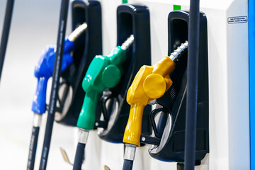 Colorful Petrol pump filling nozzles in Gas station
