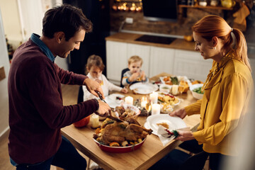 Fototapeta na wymiar Happy family enjoying in Thanksgiving dinner in dining room.