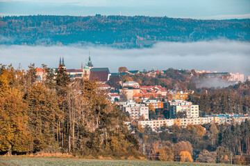 view of the city of Jihlava with Church of St. James the Greater. Autumn fall season with mist. Vysocina, Czech Republic