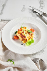 Lasagna with tomato and green leaf