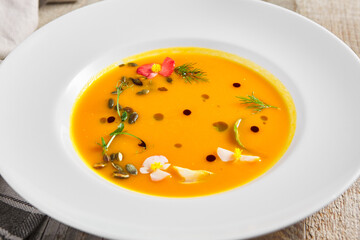 Yellow Pumpkin Soup on wooden table