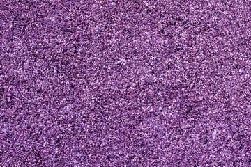 Christmas shiny lilac background made of small beads.artistic graininess effect