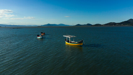 Fototapeta na wymiar Fisherman boat on the coast, aerial image from Florianópolis, Santa Catarina Brazil