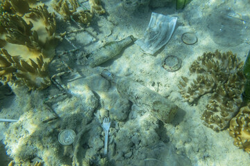 Face masks and plastic debris on bottom in Red Sea. Coronavirus COVID-19 is contributing to...