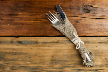 Top view of kitchen cutlery setting on grunge restaurant table.