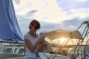 Young caucasian woman sailor enjoying summertime.
