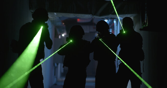 SWAT team with laser sights in dark corridor Stock Photo | Adobe Stock