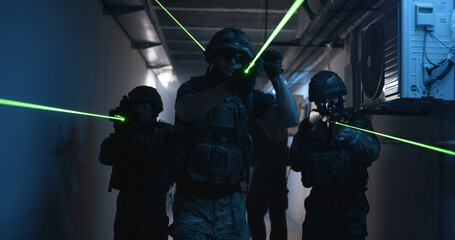 SWAT team with commander walking in dark corridor