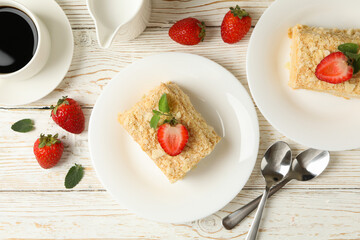 Concept of lunch with Napoleon cake on white wooden background