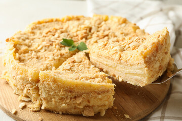 Board with delicious Napoleon cake, close up