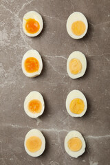 Flat lay with boiled eggs on gray background, top view