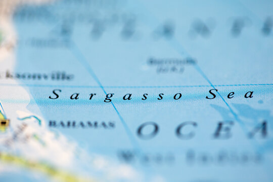 Shallow depth of field focus on geographical map location of Sargasso Sea off coast of America on atlas