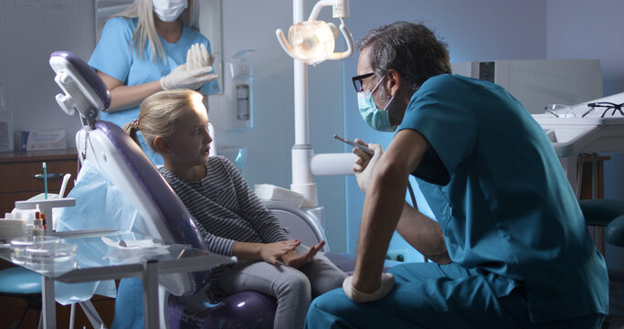 Professional pediatric dentist with little patient