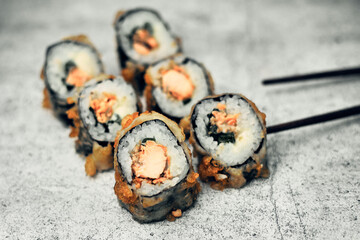 Traditional Japanese food, sushi and rolls. Ginger and wasabi, Chinese sticks. Rice and seafood food. Close up