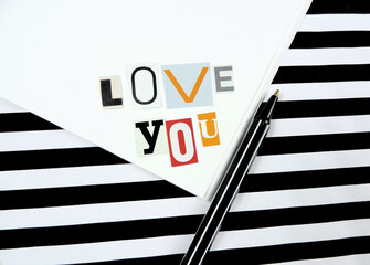 Love you - cut paper letter ,  declaration of love, combination of red black white colors, striped background